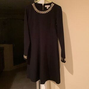 Beautiful Michael Kors black dress with gold studs around the neck and cuffs.